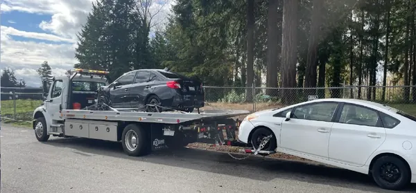Moving two vehicles in one trip