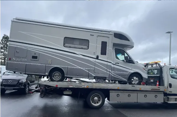 Motorhome on a flatbed in the rain