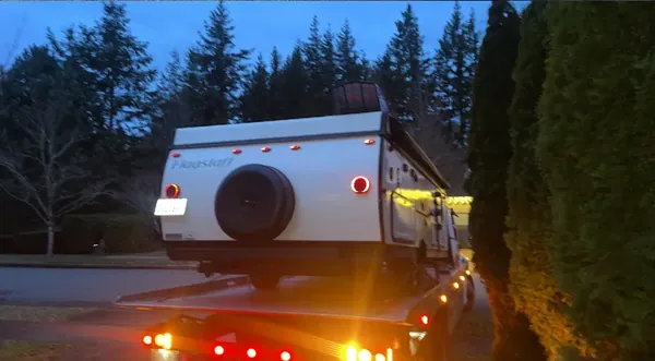 Travel trailer being moved at dusk